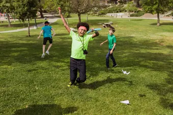 A kid leaping with joy after a good throw